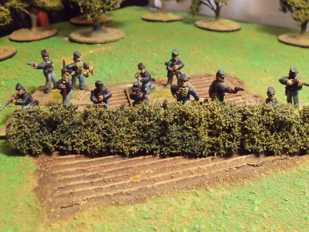 Dismounted Union cavalry taking cover.